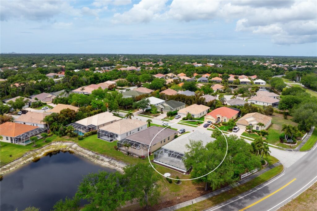 Aerial view of a suburban neighborhood with houses and greenery.