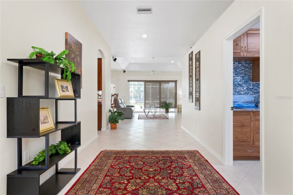 Bright, spacious living room with a red oriental rug and modern decor.