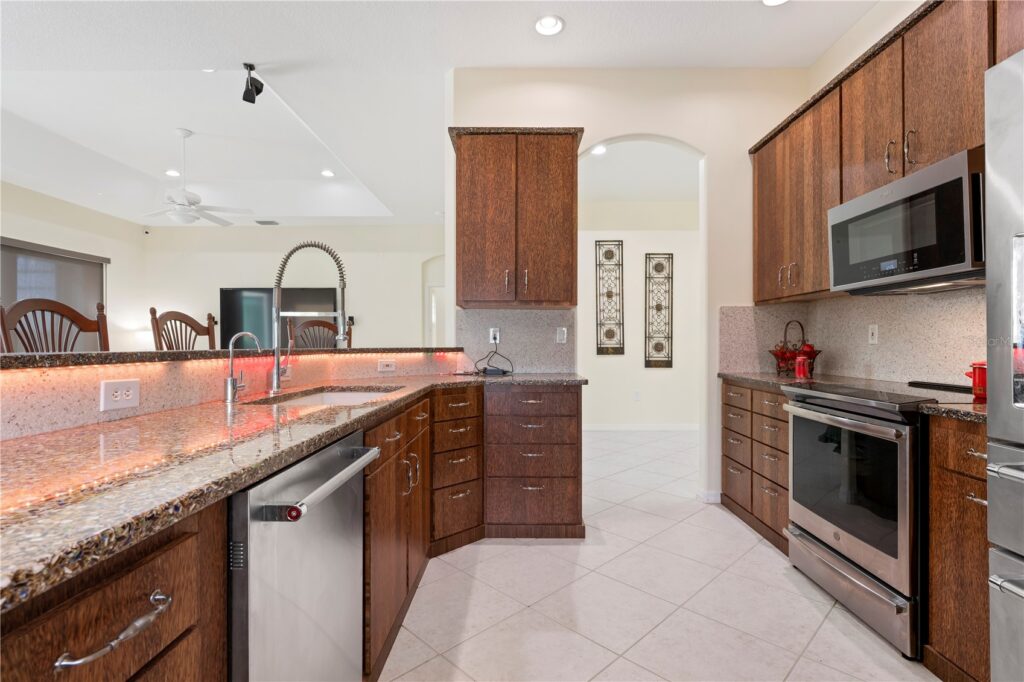 Modern kitchen with wooden cabinets and stainless steel appliances.