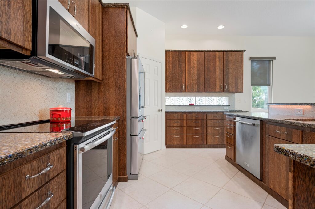 Modern kitchen with wooden cabinets and stainless steel appliances.