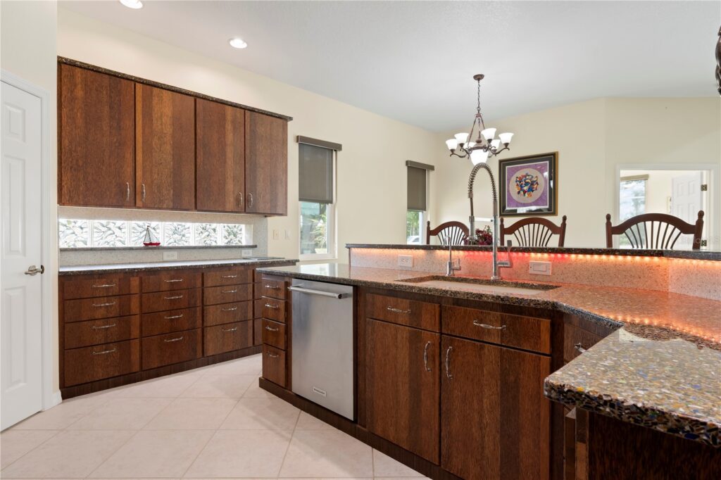 Modern kitchen with wooden cabinets and a large island.