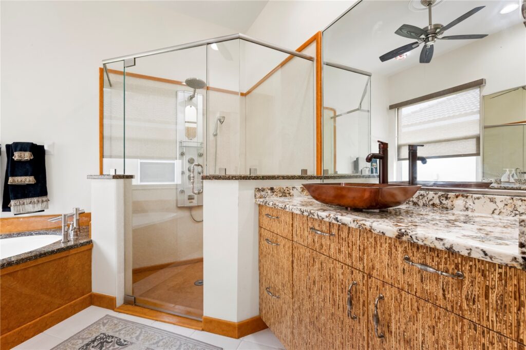 Modern rustic bathroom with natural wood and stone elements.