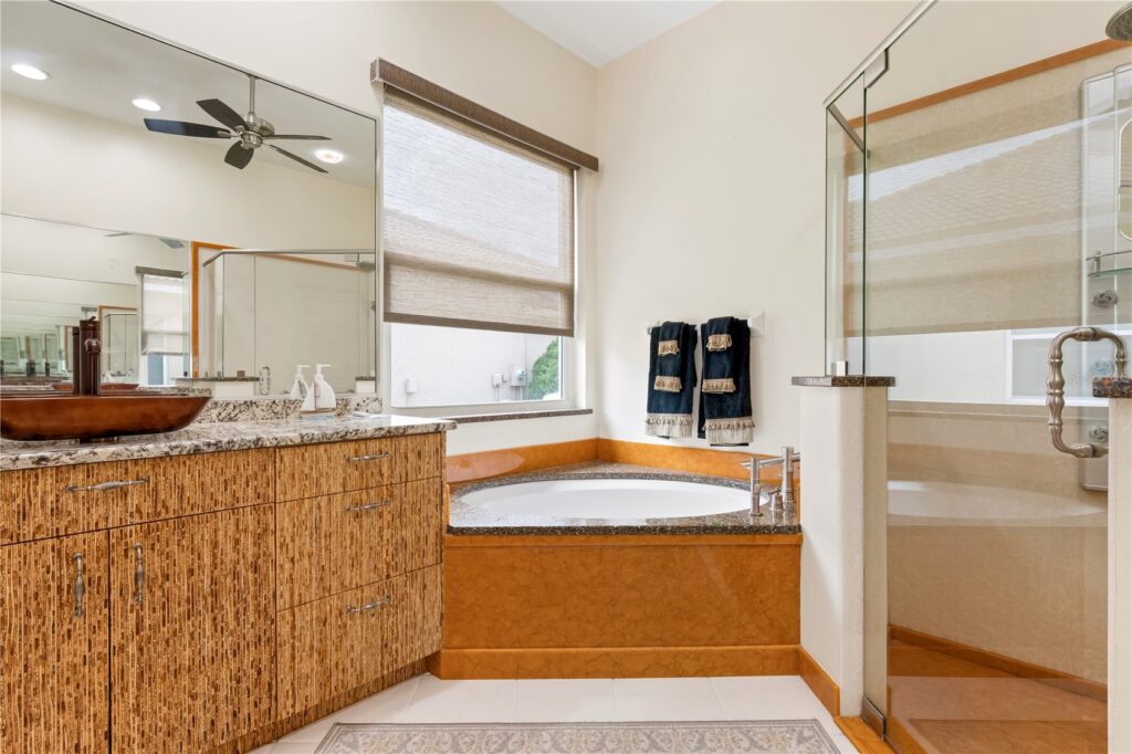 Bright bathroom with a large bathtub and wooden accents.