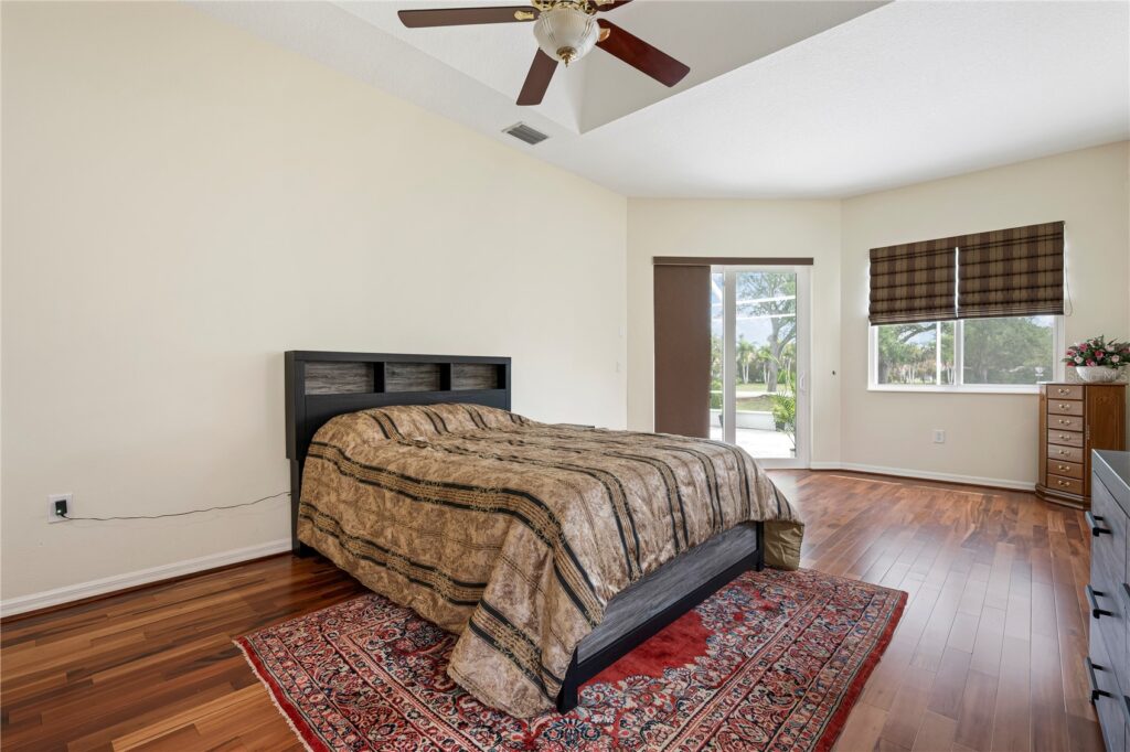 Cozy bedroom with a large bed and ceiling fan.