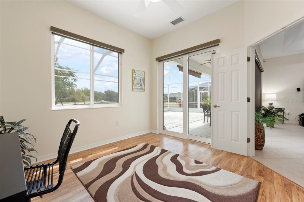 Bright room with large windows and sliding glass door.