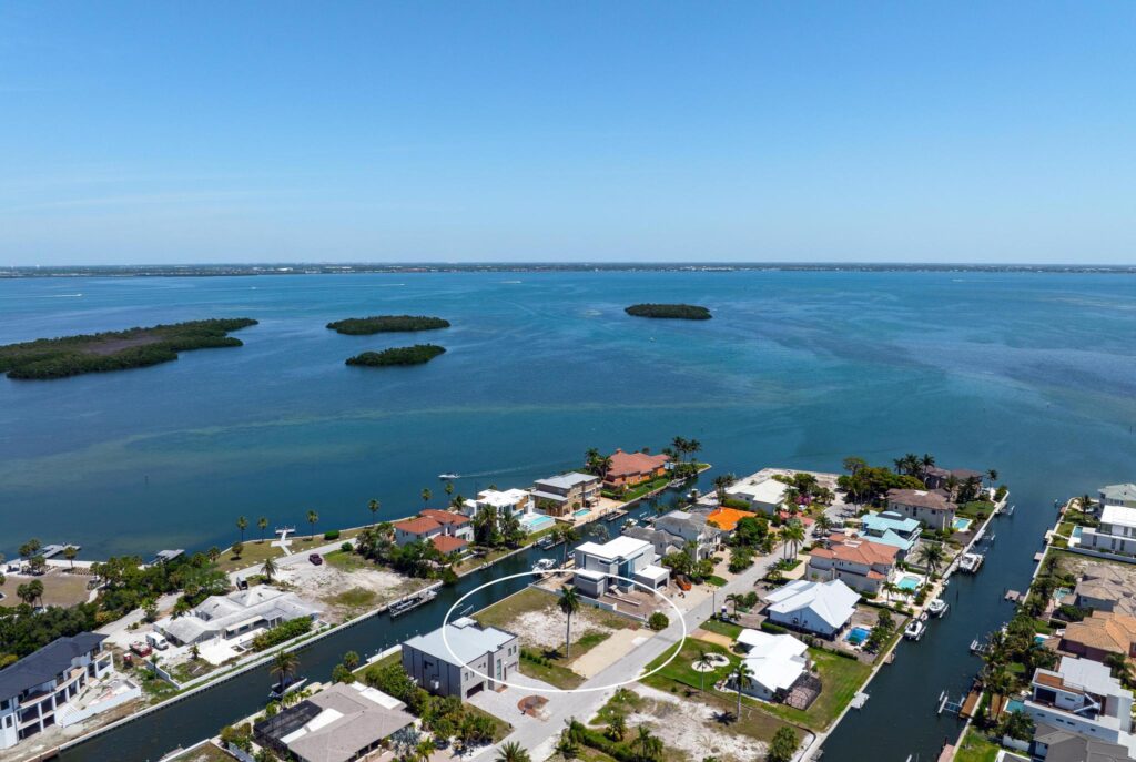 Aerial view of a coastal community with small islands in the distance.