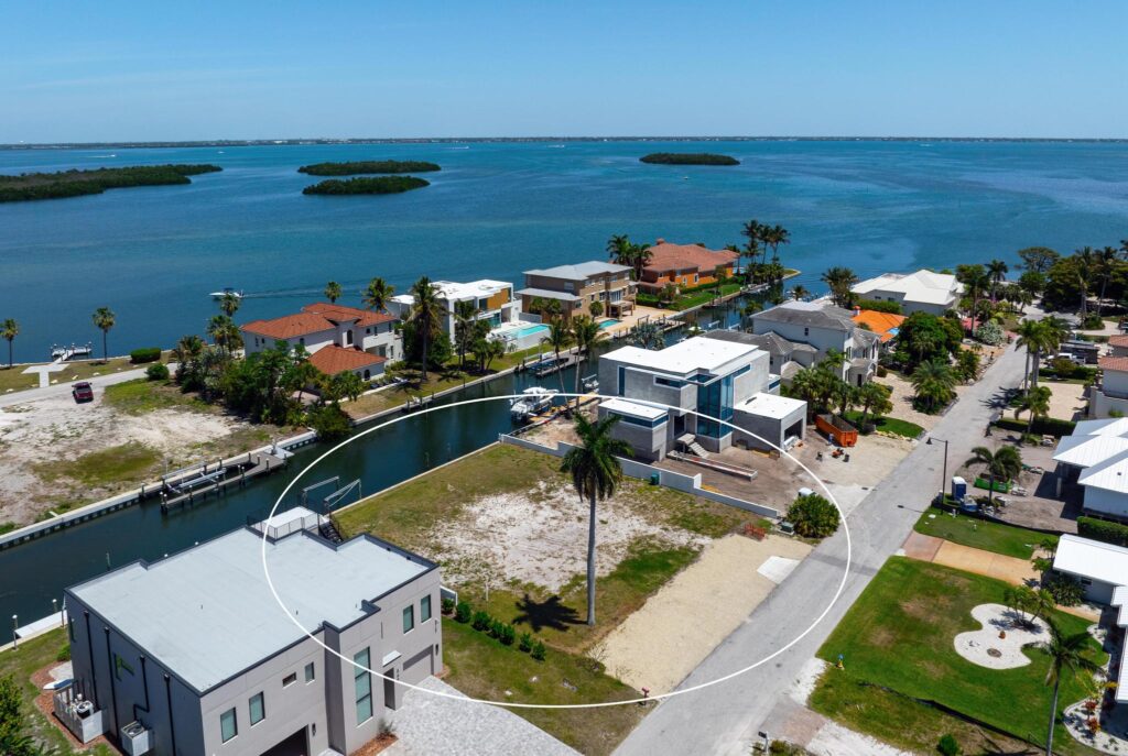 Aerial view of a waterfront neighborhood with houses and docks.
