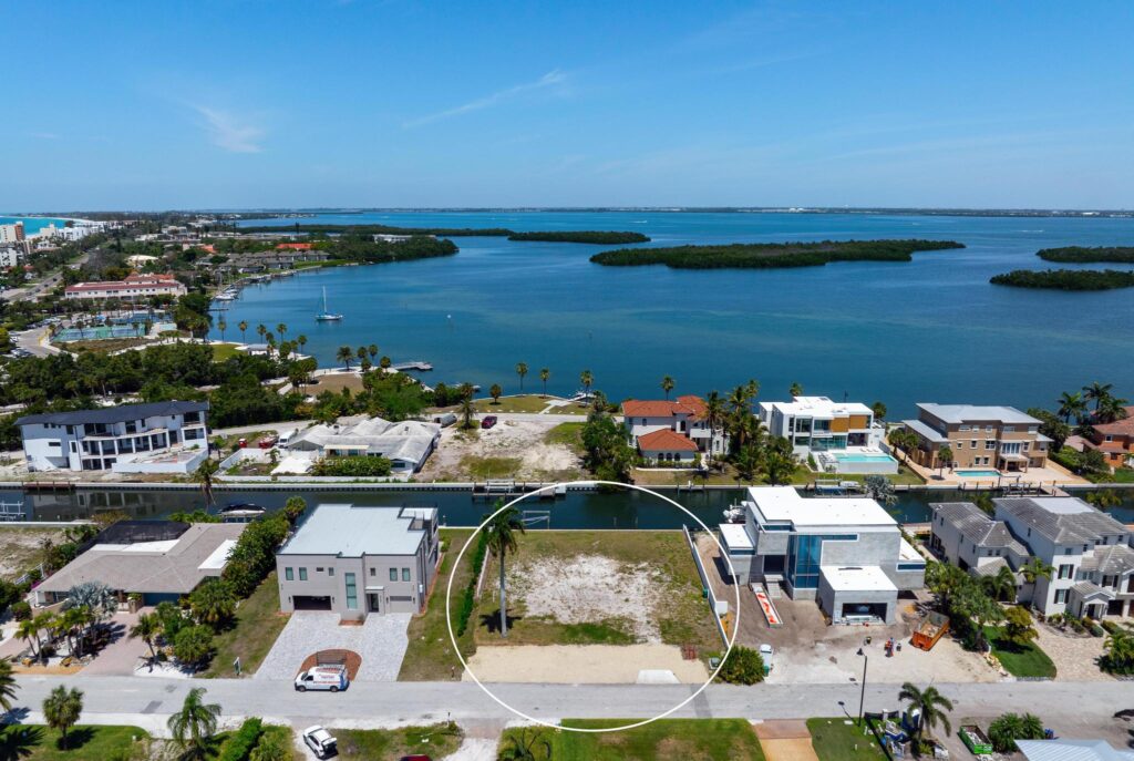 A coastal neighborhood with houses and a large body of water.