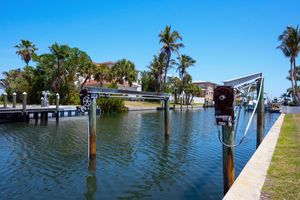 Serene waterfront scene with docks and palm trees under a clear sky.